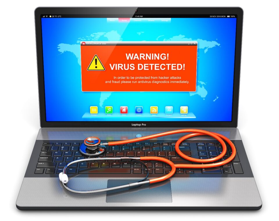 Laptop with virus warning and a stethoscope on keyboard.